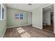 Light-filled bedroom with wood-look floors and an ensuite bathroom at 3104 E Broadway Rd -- # 287, Mesa, AZ 85204