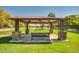 Open community pavilion with stone pillars overlooking a pond with green lawns at 3104 E Broadway Rd -- # 287, Mesa, AZ 85204