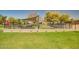 Covered picnic tables and games surrounded by green grass and an iron fence at 3104 E Broadway Rd -- # 287, Mesa, AZ 85204