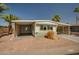 Charming single-story home featuring a covered parking area and desert landscaping at 3104 E Broadway Rd -- # 287, Mesa, AZ 85204