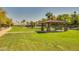 Scenic community gazebo with seating, landscaping, and a pond at 3104 E Broadway Rd -- # 287, Mesa, AZ 85204