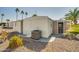 Back exterior view of the home featuring a utility box, screened in patio and rock landscaping at 3104 E Broadway Rd -- # 287, Mesa, AZ 85204
