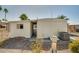 Exterior view of the home with desert landscaping, utility access and attached carport at 3104 E Broadway Rd -- # 287, Mesa, AZ 85204