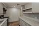 Bright kitchen with grey cabinets, stone countertops, and stainless steel appliances at 3104 E Broadway Rd -- # 287, Mesa, AZ 85204