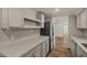 Well-lit kitchen featuring grey cabinetry, stone countertops, and stainless steel appliances at 3104 E Broadway Rd -- # 287, Mesa, AZ 85204