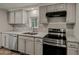 Updated kitchen featuring grey cabinets, stone countertops, and stainless steel appliances at 3104 E Broadway Rd -- # 287, Mesa, AZ 85204