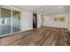 Open layout living room featuring wood-look floors and sliding door access to the screened-in patio at 3104 E Broadway Rd -- # 287, Mesa, AZ 85204