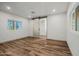 Bedroom with wood-look flooring, natural light, and a barn door to the attached bathroom at 3104 E Broadway Rd -- # 287, Mesa, AZ 85204