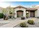 Inviting front entrance showcasing charming Southwestern architecture, desert landscaping, and a quaint walkway to the door at 34457 N Legend Trail Pkwy # 1003, Scottsdale, AZ 85262