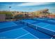 Multiple blue tennis and pickleball courts with nets, ready for recreational games and active community engagement at 34457 N Legend Trail Pkwy # 1003, Scottsdale, AZ 85262