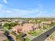 Aerial perspective of a home with a four-car garage, lush landscaping, and a well-maintained front yard at 3446 E Knoll St, Mesa, AZ 85213