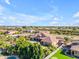 A large property features an inviting pool and lush landscaping, nestled within a picturesque neighborhood at 3446 E Knoll St, Mesa, AZ 85213