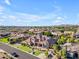 Wide aerial view of a home in a neighborhood with meticulously maintained yards and mature trees at 3446 E Knoll St, Mesa, AZ 85213