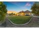 Expansive backyard features lush lawn, mature trees, swimming pool, and covered patio for outdoor entertaining at 3446 E Knoll St, Mesa, AZ 85213
