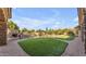 Lush backyard with a built-in barbecue area, swimming pool and ample green space, ideal for outdoor entertaining and relaxation at 3446 E Knoll St, Mesa, AZ 85213