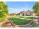 A well-manicured backyard with green grass and professional landscaping at 3446 E Knoll St, Mesa, AZ 85213