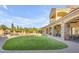 Spacious backyard featuring a covered patio, manicured lawn, and a pool with rock accents, perfect for outdoor living and entertaining at 3446 E Knoll St, Mesa, AZ 85213