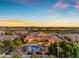A resort-style backyard featuring a luxurious pool, mature landscaping, and covered patio at 3446 E Knoll St, Mesa, AZ 85213