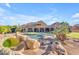 A backyard featuring a pool with slide, spa, patio, and pristine landscaping, providing an outdoor oasis at 3446 E Knoll St, Mesa, AZ 85213