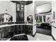 Luxurious bathroom with black cabinets, marble countertop, and adjacent bedroom creates a sophisticated living space at 3446 E Knoll St, Mesa, AZ 85213