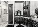 Bathroom with black cabinets, marble countertops, and a glass-enclosed shower at 3446 E Knoll St, Mesa, AZ 85213