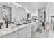 Large bathroom featuring marble counters, stone accent wall, and vanity sinks at 3446 E Knoll St, Mesa, AZ 85213