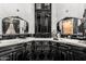 Elegant bathroom vanity with black cabinets, white marble countertop, and decorative mirrors provides an upscale feel at 3446 E Knoll St, Mesa, AZ 85213