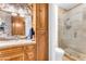 Bathroom with stone wall, wood vanity, and glass shower at 3446 E Knoll St, Mesa, AZ 85213