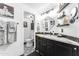 A stylish bathroom features modern fixtures, a black vanity, and black and white tile at 3446 E Knoll St, Mesa, AZ 85213