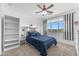 Bright bedroom featuring a ceiling fan, closet, and view from the window at 3446 E Knoll St, Mesa, AZ 85213