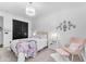 Bright bedroom featuring a chandelier, closet, and pink lounge chair at 3446 E Knoll St, Mesa, AZ 85213