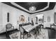 Formal dining room with chandelier, large table, and views to the entryway and kitchen at 3446 E Knoll St, Mesa, AZ 85213