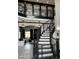A grand foyer features a curved staircase, patterned tile, and views into the living room at 3446 E Knoll St, Mesa, AZ 85213