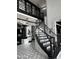 Elegant foyer featuring a striking black and white color scheme and a grand, spiraling staircase at 3446 E Knoll St, Mesa, AZ 85213