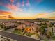 Expansive desert home featuring manicured landscaping, mature trees and hardscape with stunning sunset at 3446 E Knoll St, Mesa, AZ 85213