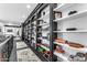 Hallway showcasing custom black built-in shelving filled with books and decorative items, with a stylish rug at 3446 E Knoll St, Mesa, AZ 85213