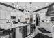 The kitchen features an island with marble countertops, stainless steel appliances and black and white patterned floors at 3446 E Knoll St, Mesa, AZ 85213