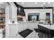 Bright kitchen boasts white cabinets, marble countertops, black range hood, stainless steel appliances, and patterned tile floors at 3446 E Knoll St, Mesa, AZ 85213