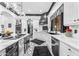 Modern kitchen with white cabinetry, stainless steel appliances, and geometric tiled floor at 3446 E Knoll St, Mesa, AZ 85213