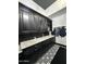 Laundry room featuring black cabinets, modern countertop, and designer floor tiles at 3446 E Knoll St, Mesa, AZ 85213