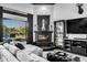 Comfortable living room featuring a stone fireplace, large windows, and stylish decor at 3446 E Knoll St, Mesa, AZ 85213