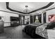 A spacious main bedroom features dark wood trim, chandelier, and a large window showcasing ample natural light at 3446 E Knoll St, Mesa, AZ 85213
