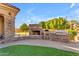 Outdoor kitchen with stone surround, built-in grill, and seating area, perfect for outdoor entertaining at 3446 E Knoll St, Mesa, AZ 85213