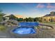 Resort-style pool and spa with rock accents and lush landscaping, creating a serene oasis for relaxation and enjoyment at 3446 E Knoll St, Mesa, AZ 85213
