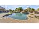 Beautiful pool features a rock waterfall, lush landscaping, and a relaxing oasis for enjoying the outdoors at 3446 E Knoll St, Mesa, AZ 85213