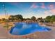 Sparkling pool showcasing a stone waterfall feature with meticulously landscaped surroundings, creating a serene outdoor oasis at 3446 E Knoll St, Mesa, AZ 85213