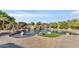 Lovely backyard pool and patio with rock waterfall feature, lush landscaping, and brick pavers for outdoor enjoyment at 3446 E Knoll St, Mesa, AZ 85213
