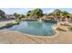 Beautiful backyard pool and patio with rock waterfall feature, and well manicured landscaping, perfect for outdoor enjoyment at 3446 E Knoll St, Mesa, AZ 85213