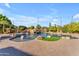 A gorgeous in-ground swimming pool and grotto with lush landscaping and beautiful brick pavers at 3446 E Knoll St, Mesa, AZ 85213