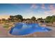 Stunning pool featuring rock waterfall, lush landscaping, and a unique design, perfect for outdoor relaxation and entertainment at 3446 E Knoll St, Mesa, AZ 85213